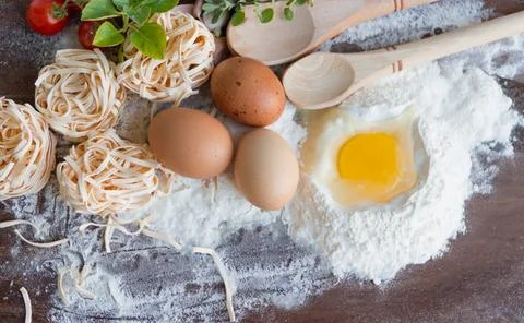 Ingredients preparation spaghetti with eggs, tomatoes herbs and spices Stock Photos