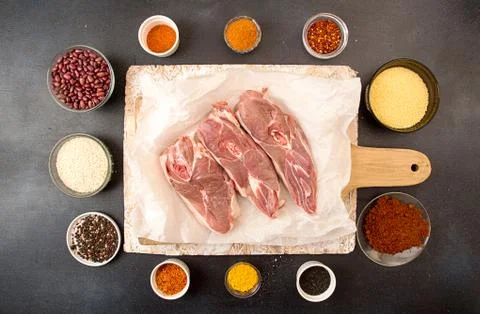 Ingredients for preparing dinner. Copped raw lamb pieces steaks Stock Photos