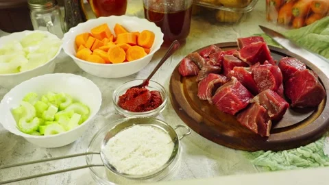 Ingredients for preparing Irish stew: beef, potatoes, carrots and herbs Stock Footage 98238032