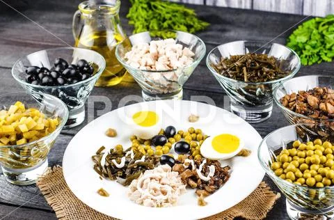 Ingredients for salad in transparent plates on a black wooden background. Fri Stock Photos