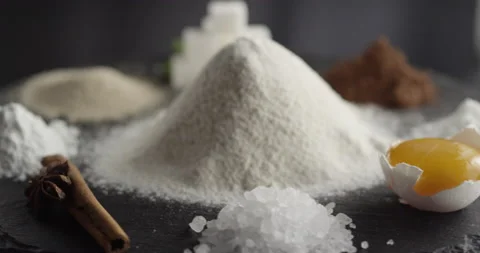 Ingredients spin in a circle flour cocoa egg sugar cinnamon soda yeast Video stock 198560849