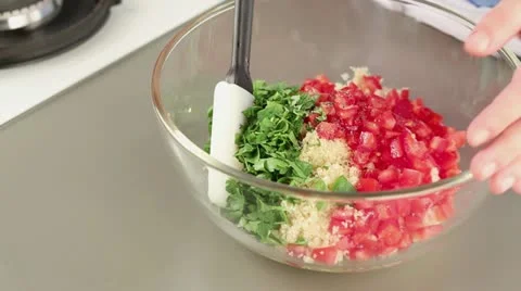 Ingredients for tabbouleh being mixed Stock Footage 24672866