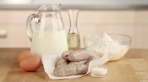 Ingredients for toad in the hole (sausages in batter, England) Stock Footage 24671728