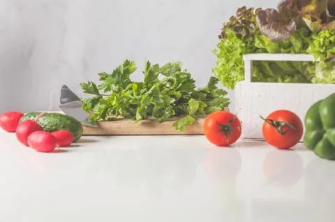 Ingredients for vegetable salad on a white table. Healthy vegan lifestyle con Stock-Fotos