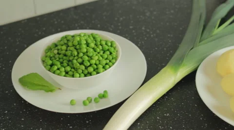 Ingredients for vegetarian soup: potato, pea, leek, mint Stock Footage 59606177