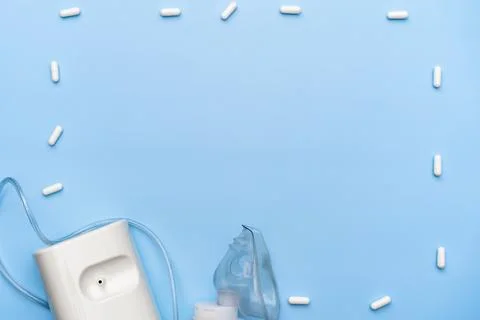 Inhaler on a blue background, space for text, top view, flat lay Stock Photos