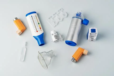 Inhalers, peak flow meter, plastic ampoules, nebulizer components, and metal Stock Photos
