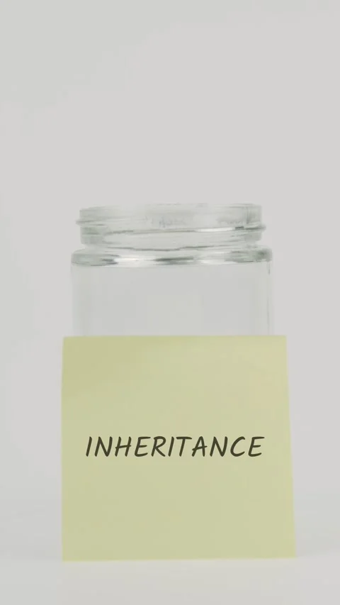 Inheritance text or word on yellow sticky note attached to glass jar Stock Footage 311744551
