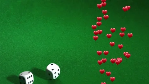 Initial nudge sending two white dice rolling on green felt as red hearts Stock Footage 328417208