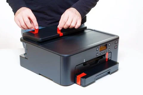 Initial Setup of a Brand New Printer: Peeling Transport Stickers Off Stock Photos