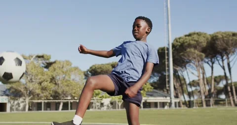 Initial short kicks are starting soccer ball juggling on turf while practicing Stock-Footage 338062281