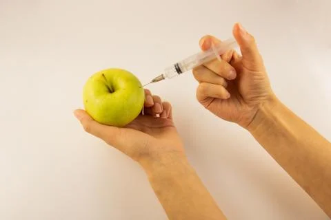Inject the solution into the apple, inject it into the apple Stock Photos