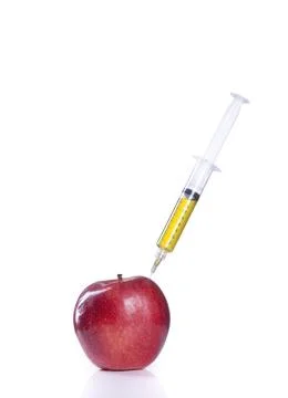 Injecting an apple. Stock Photos