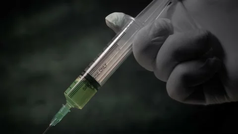 Injecting a drug, using a needle and a syringe. A close up, template shot Stock Footage 227781821