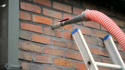 Injecting insulation into a cavity wall Stock Footage