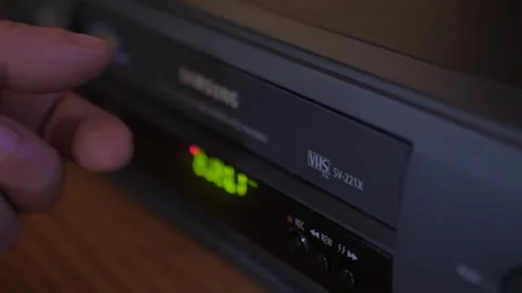 Injecting remove video vhs cassette into video recorder 4k Video stock 281868406