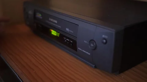 Injecting remove video vhs cassette into video recorder 4k Video stock 281868413