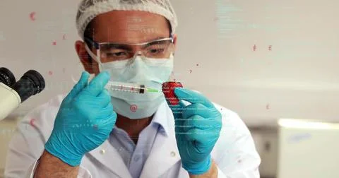 Injecting tech in lab coat inserting liquid with syringe into strawberry at lab Stock Photos