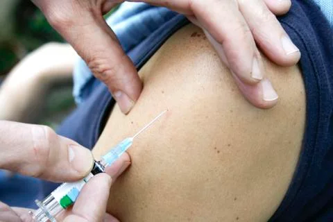 Injection in arm Stock Photos