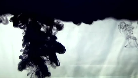 Injection of Black Ink into Clear Water Creating Abstract Flow and Smoke Effect Stock Footage 340654158