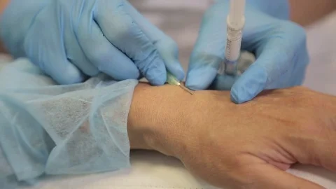 Injection Botox Needle Syringe under the Woman Hand Skin, tightening Procedure Stock Footage 78725034