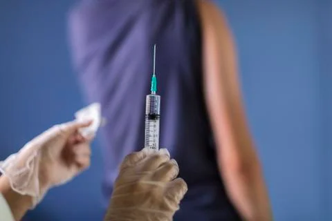Injection, the doctor vaccinates the patient Stock Photos