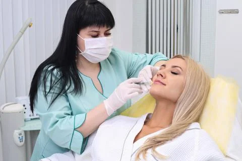 Injection in her lips. Stock Photos