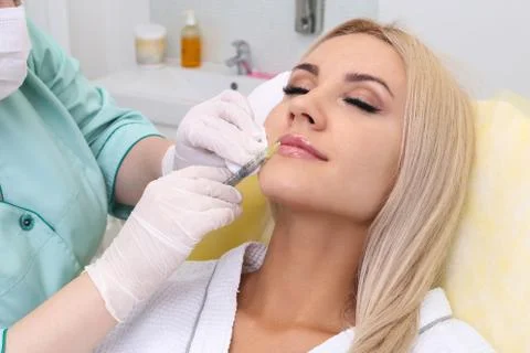 Injection in her lips. Stock Photos