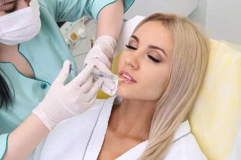 Injection in her lips. Stock Photos