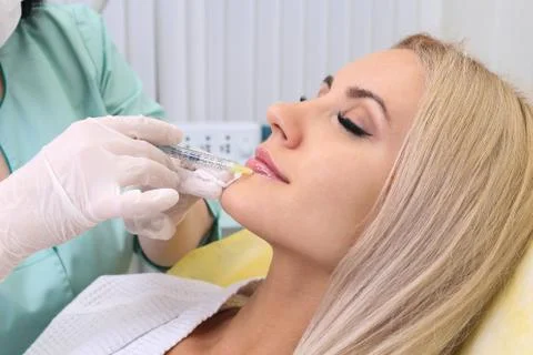 Injection in her lips. Stock Photos