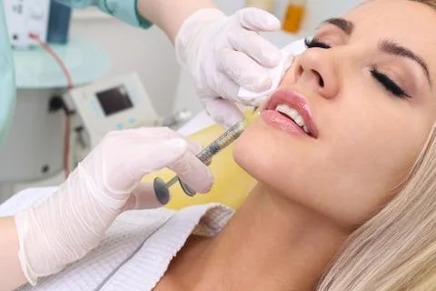 Injection in her lips. Stock Photos