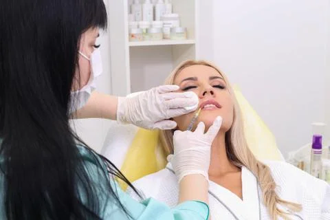 Injection in her lips. Stock Photos