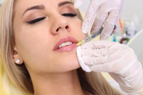 Injection in her lips. Stock Photos