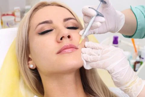 Injection in her lips. Stock Photos