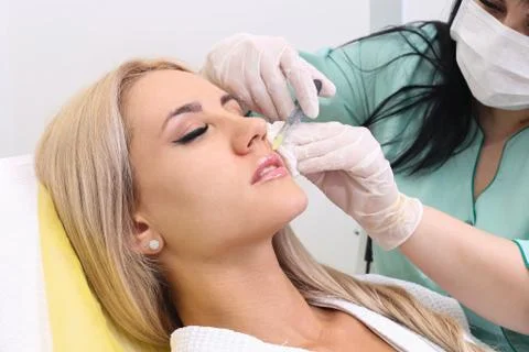 Injection in her lips. Stock Photos