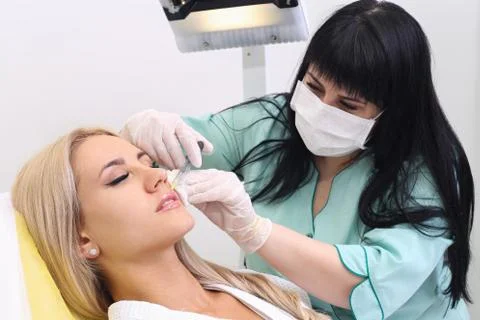 Injection in her lips. Stock Photos