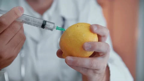 Injection into lemon - fruit and syringe chemical GMO food. Close-up. Stock Footage 146263786