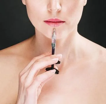 Injection on the lips of the model Stock Photos