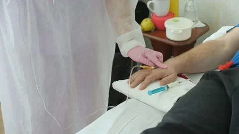 Injection of medication through a dropper installed in the person's hand. Stock Footage 144205758