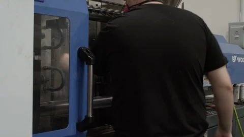 Injection molding machine makes face masks in American manufacturing factory Stock Footage 129987626