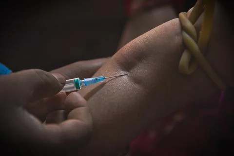 The injection needle has been inserted into the woman's hand Stock Photos