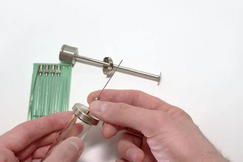 Injection needle's manual setting on reusable medical syringe Stock Photos