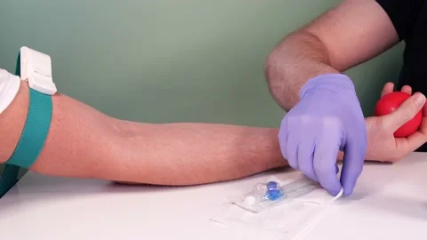Injection process. Paramedic prepares the patient for blood donation. Video stock 145289071