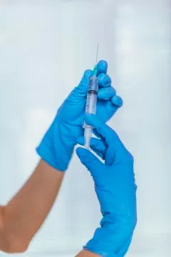 Injection, syringe in hand Stock Photos