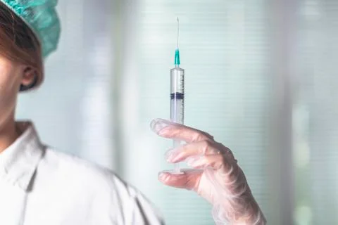 Injection, syringe in hand Stock Photos