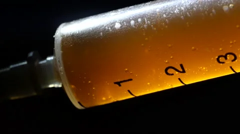 Injection with a syringe, macro closeup. 4K UHD Stock Footage 63317004