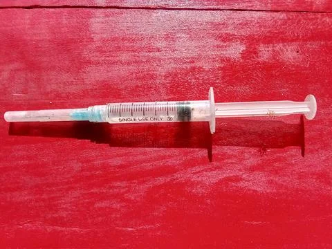 Injection tool with a red background. Фото