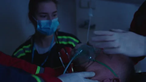 Injured elderly person getting first aid inside ambulance Stock Footage 283114997