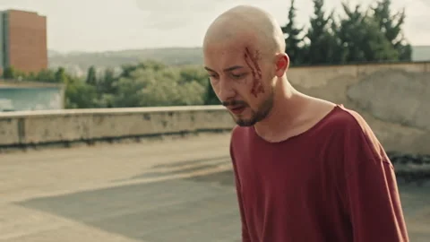 Injured suspect bleeding while police is chasing him Stock Footage 283063331