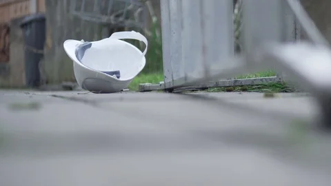 Injury At Work, Hard Hat Of Worker Fallen Off Ladder, Compensation Accident 4K Stock Footage 86998516